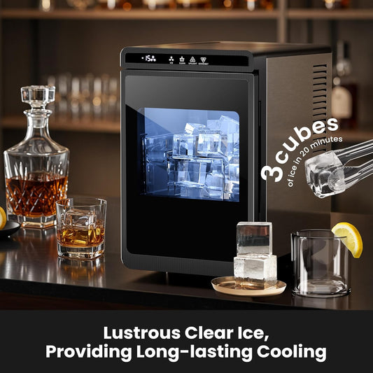 Ice cube maker on a bar counter with glasses of whiskey and ice cubes.