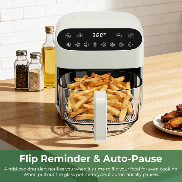 Air fryer with glass basket containing fries on a kitchen counter, with text about flip reminder and auto-pause feature.
