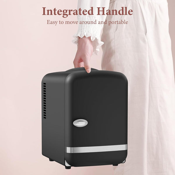 Black suitcase with an integrated handle on a light pink background