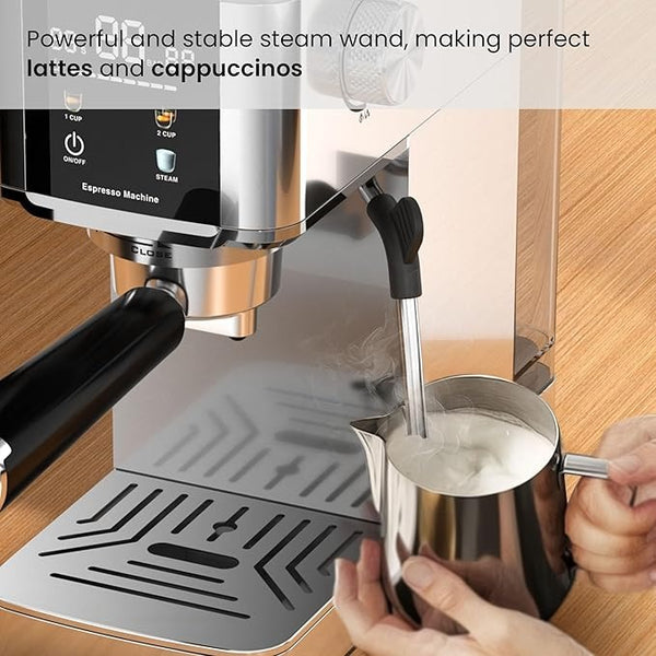 Espresso machine with steam wand being used to make latte art on a wooden surface.