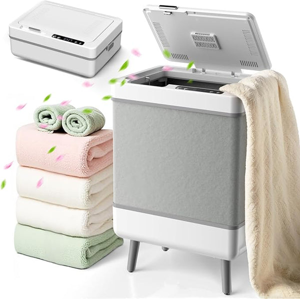 Portable washing machine with folded towels and a blanket on a white background