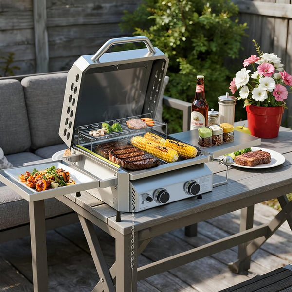 Portable grill on a wooden table with food and drinks outdoors