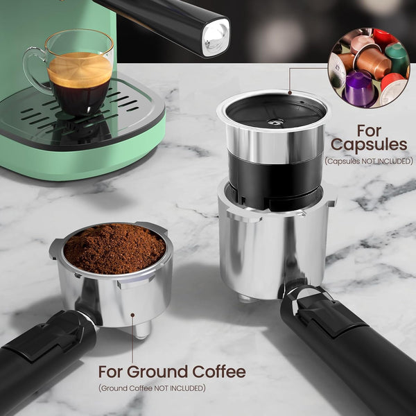 Coffee grinder and coffee maker on a marble surface with capsules and ground coffee.