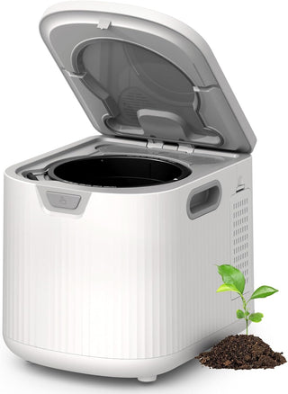 White and gray compost bin with an open lid on a white background, featuring a small plant and soil.