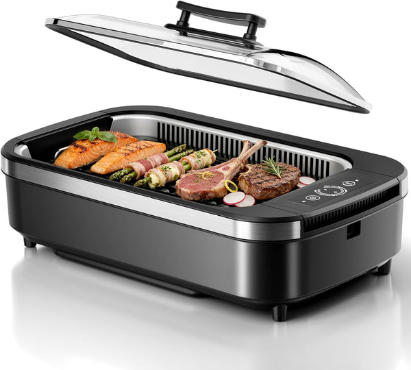 Black and silver electric grill with food on a white background
