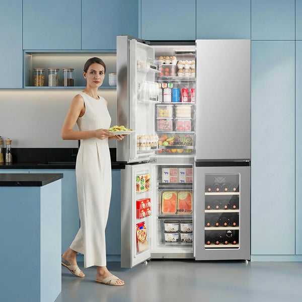 Woman standing next to a large refrigerator with open doors displaying various food items in a kitchen.