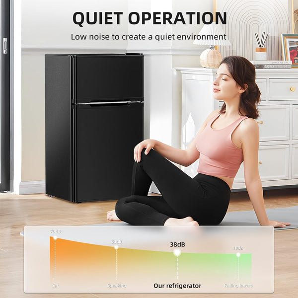 Woman sitting on a yoga mat in a room with a black refrigerator, with text about quiet operation.