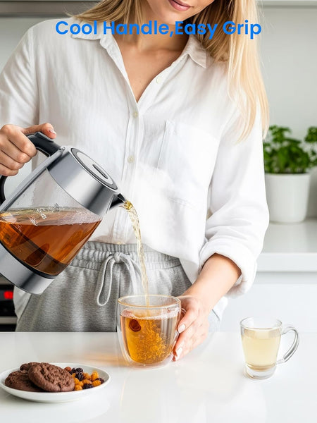 Person pouring tea from a glass teapot into a cup with cookies and a plant in the background.