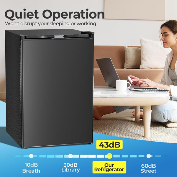 Black refrigerator with a woman using a laptop, emphasizing quiet operation.