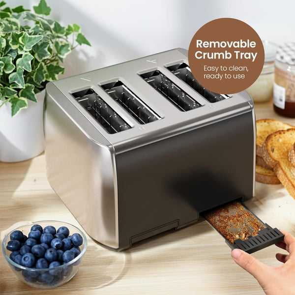 Stainless steel toaster with removable crumb tray on a kitchen counter, surrounded by toast, blueberries, and a plant.